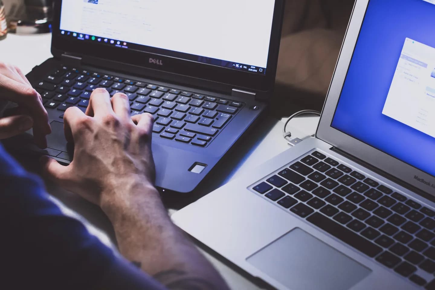 Two laptops being used side by side.