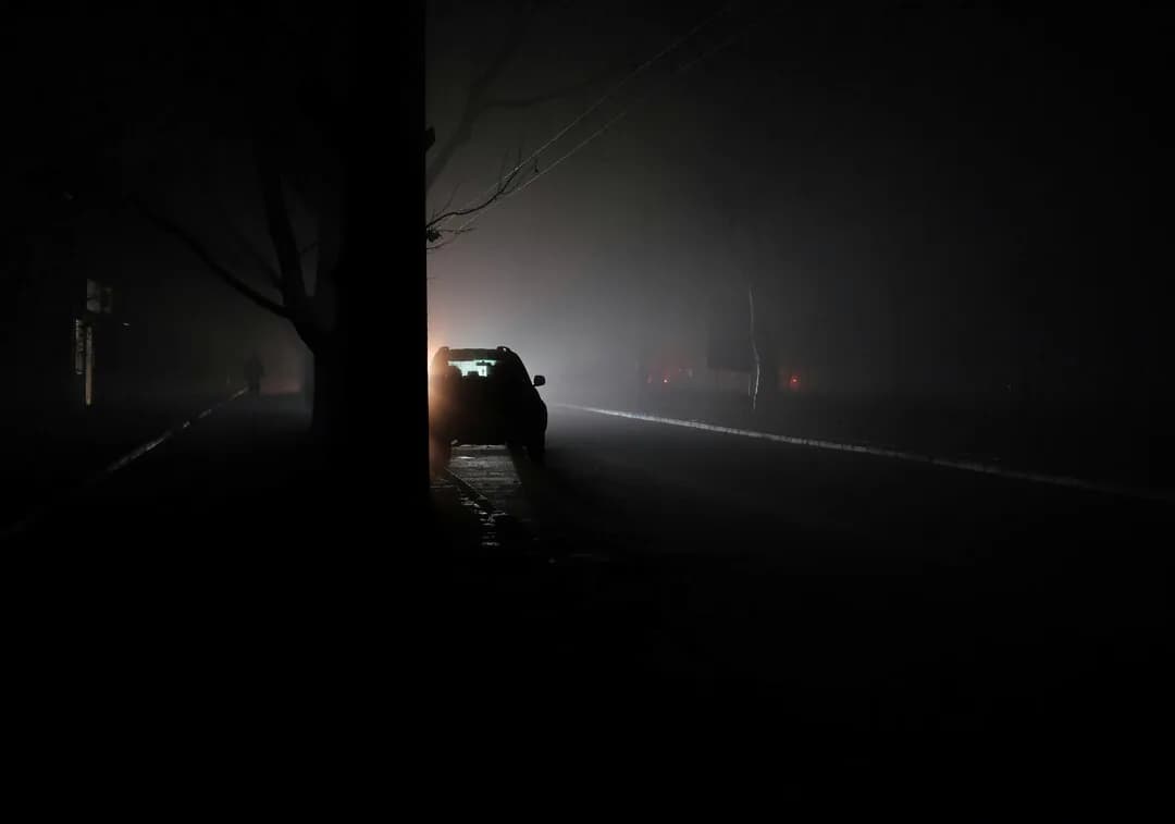 A dimly lit street at night.