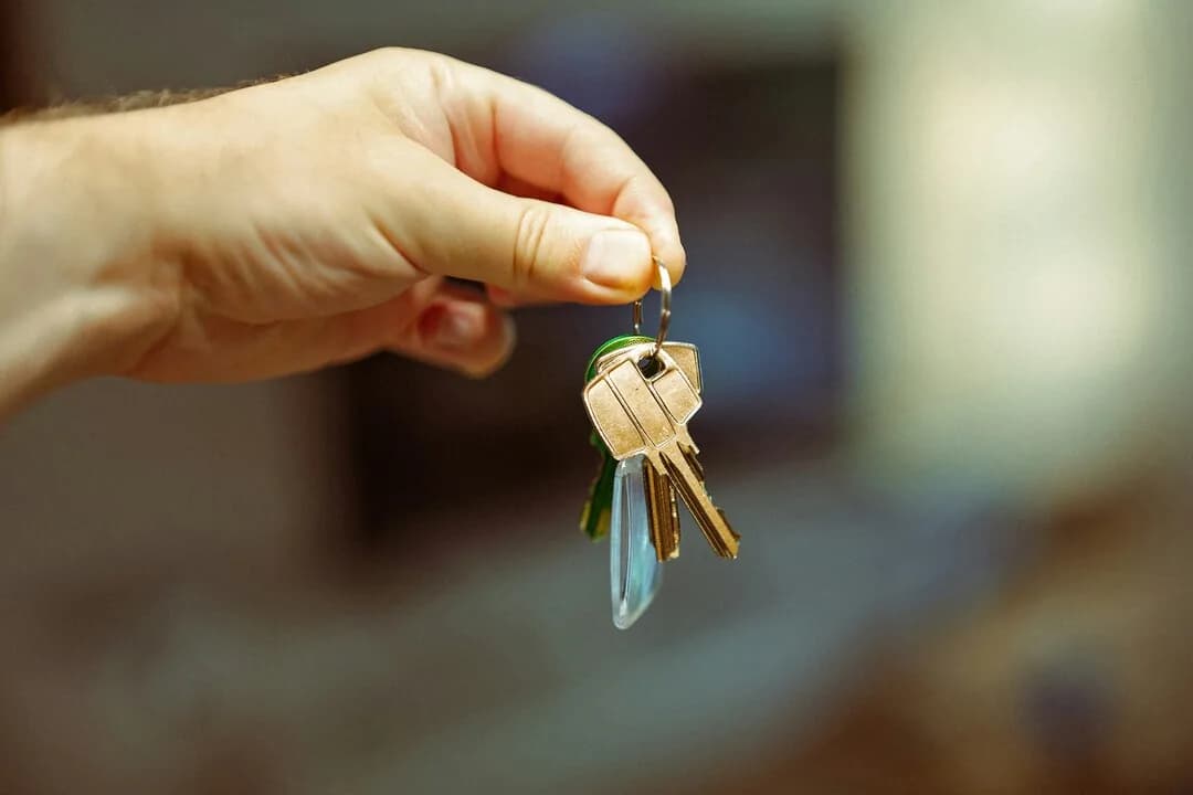A hand holding a set of keys.