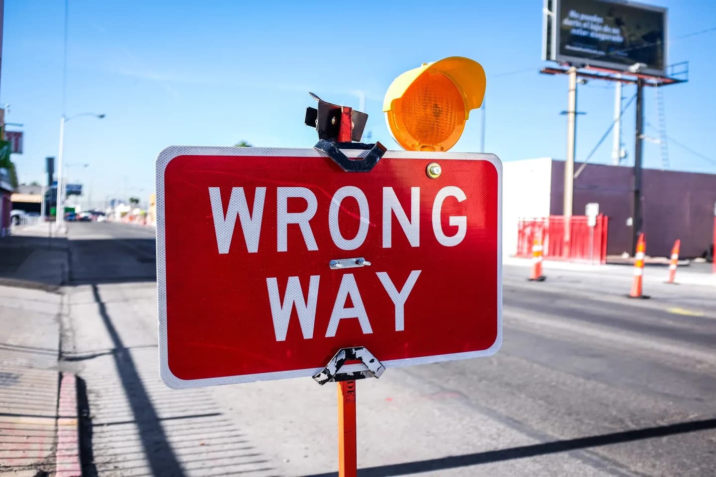 A red Wrong Way road sign.