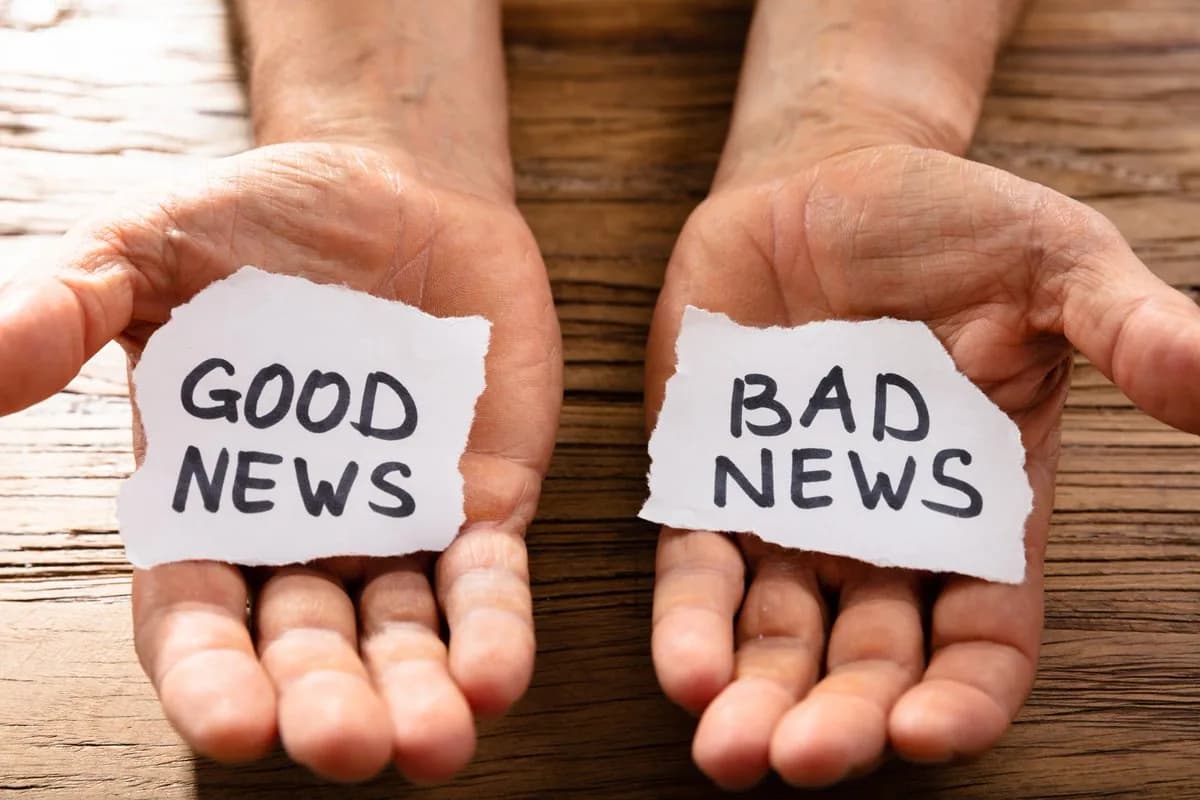 Hands holding notes reading Good News and Bad News.